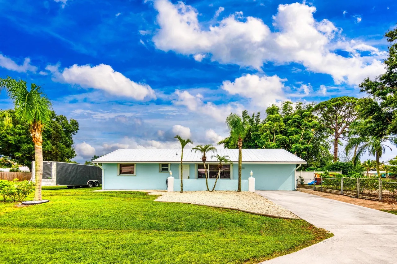 Single-story home with palm trees at 2184 SE Washington St N, Stuart, FL